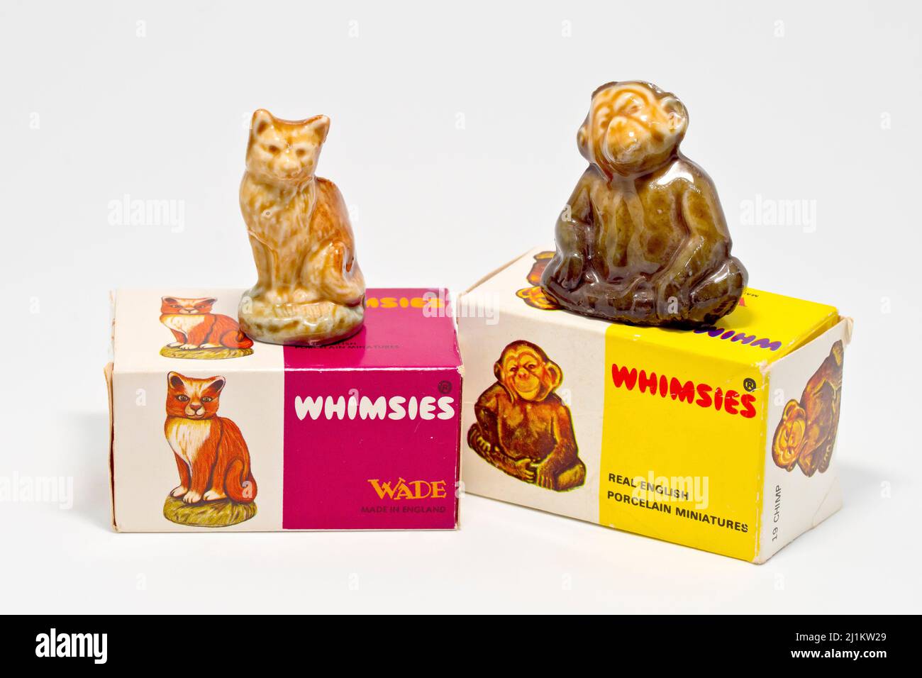 Close up of two Wade Whimsies with boxes, small porcelain animal miniatures popular with collectors since the 1950s, against a white background. Stock Photo