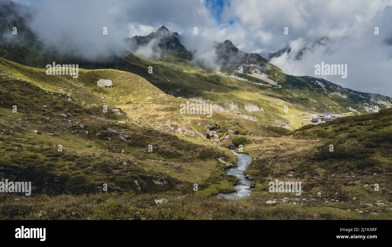Group hiking at waterfall elevation path in Hintertux Stock Photo