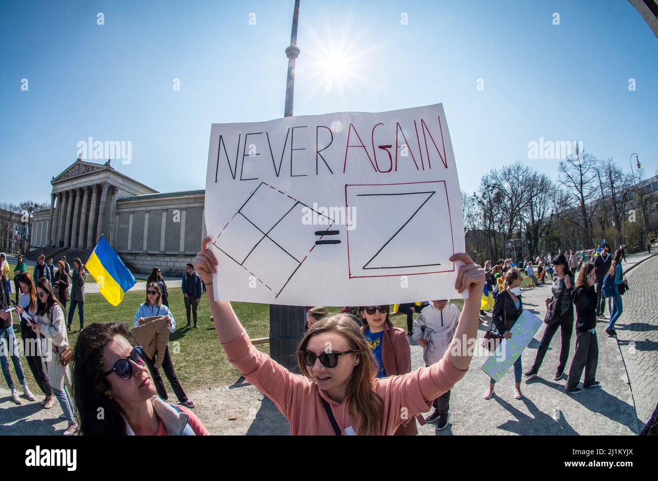 Munich, Bavaria, Germany. 26th Mar, 2022. Demonstrators against the war in Ukraine display an altered Swastika (Hakenkreuz) that is altered to avoid running afoul of the laws. Increasingly, the ''Z'' symbol on Russian equipment is being seen as the new Swastika. After a month of brutal warfare where Russia has chosen to destroy entire cities such as Mariupol when they don't surrender, Ukrainians, Germans, Russians, and Belarusians are demanding consequential action from the German government who has been discovered to largely not participate in sanctions against oligarchs and other figures, l Stock Photo