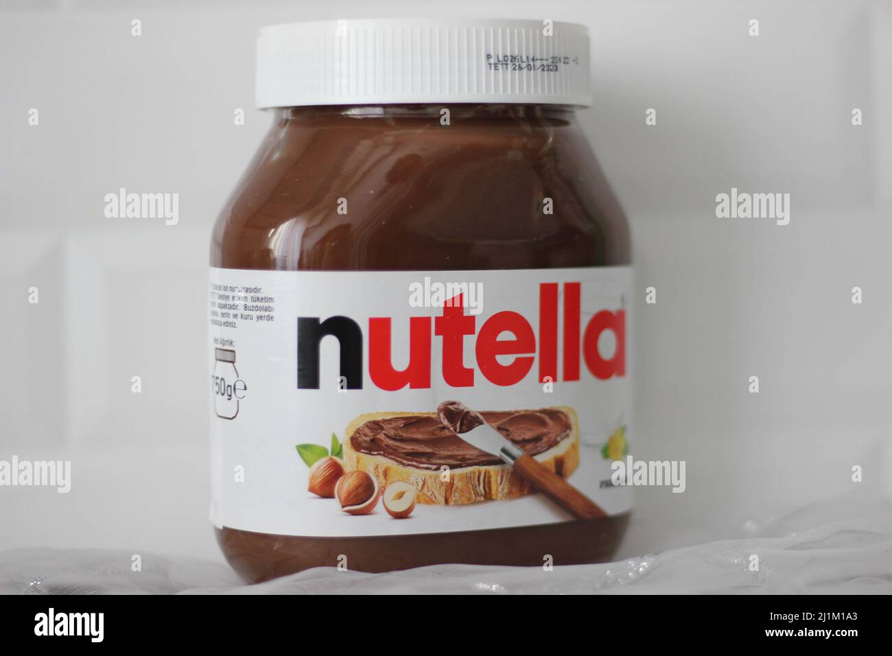 Closeup of mini Nutella container on white background Stock Photo