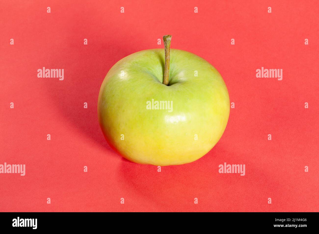 white apple on red background Stock Photo