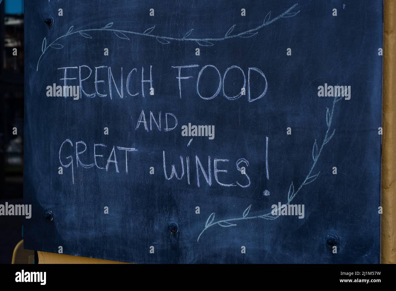 French food and great wines. Blackboard sign on restaurant wall. Stock Photo