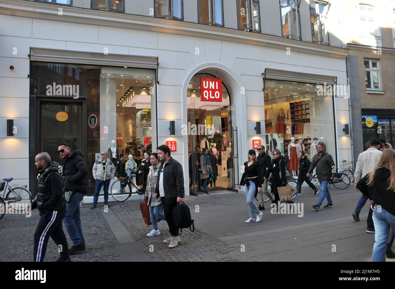 Copenhagen/Denmark/.26 .March 2022/.Saturdays shoppers pass by and at UNIQLO  store on stroeget in Copenhagen . (Photo..Francis Dean/Dean Pictures Stock  Photo - Alamy