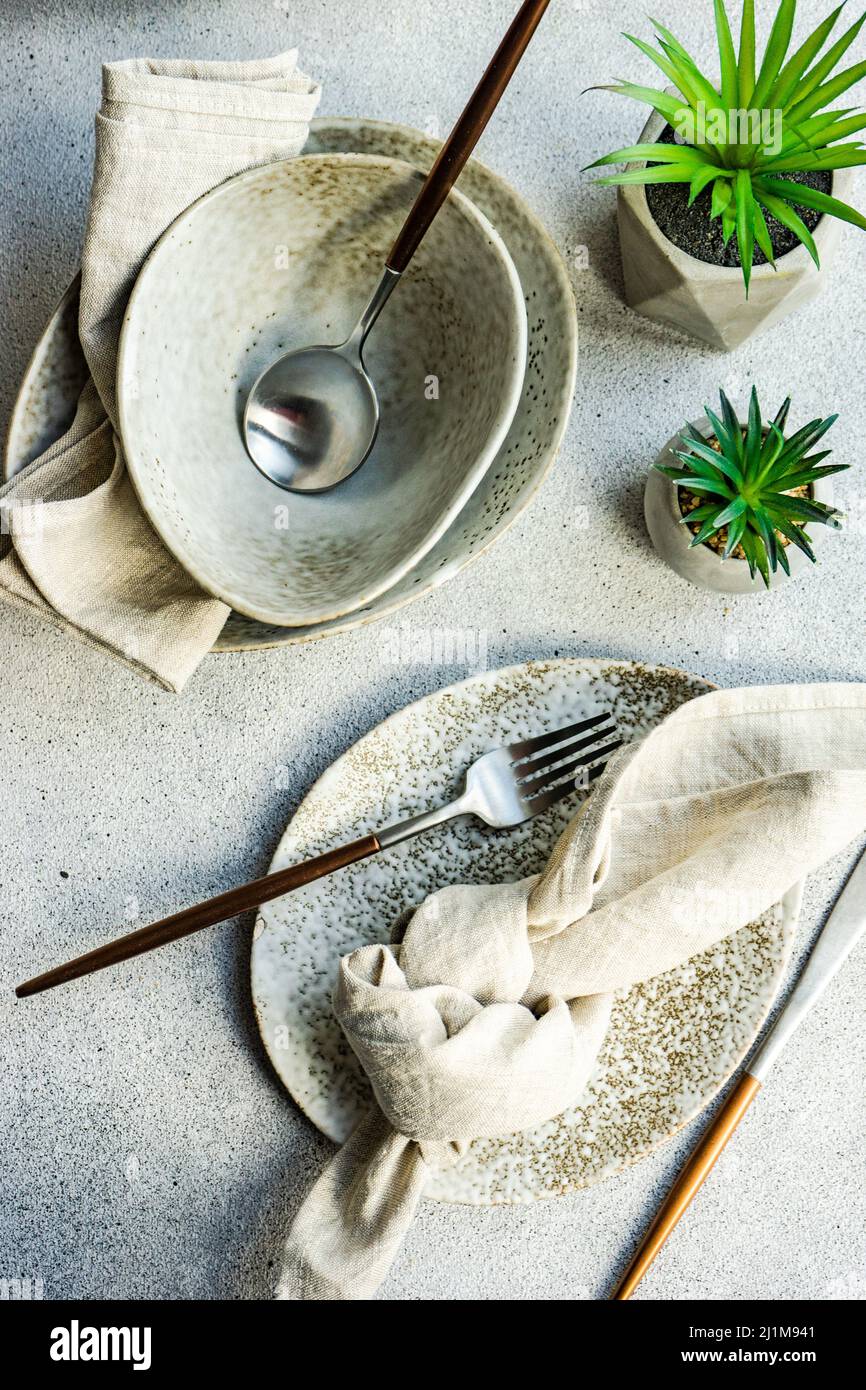 Minimalistic table setting on concrete background Stock Photo