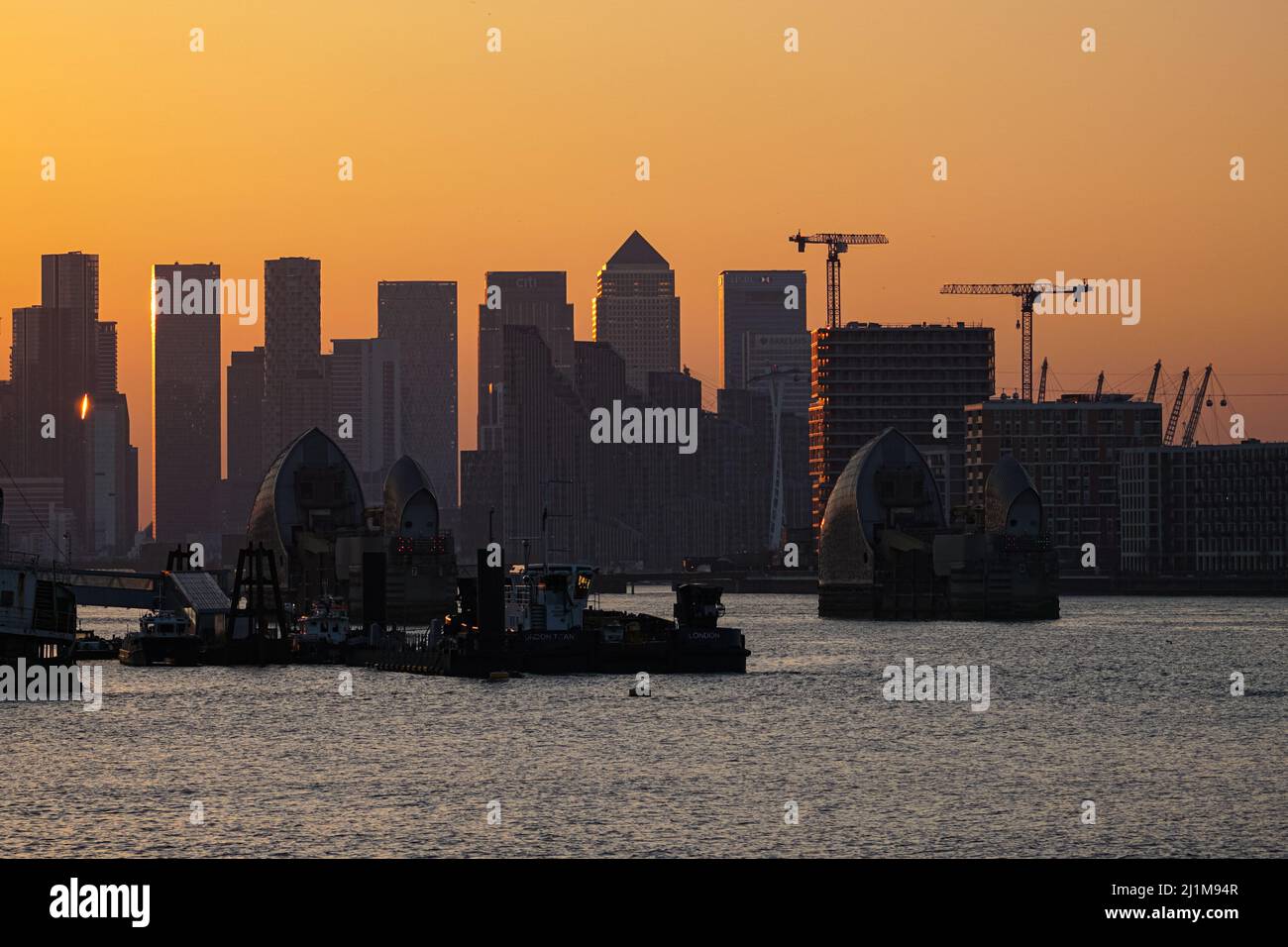 London, UK. 26th Mar, 2022. UK Weather: Sunset sky behind Canary Wharf skyscrapers. Credit: Marcin Rogozinski/Alamy Live News Stock Photo