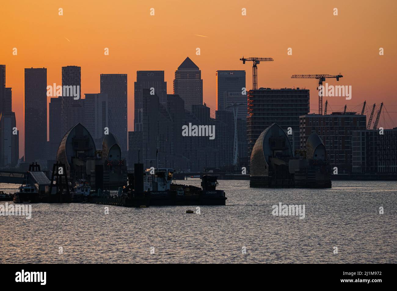 London, UK. 26th Mar, 2022. UK Weather: Sunset sky behind Canary Wharf skyscrapers. Credit: Marcin Rogozinski/Alamy Live News Stock Photo