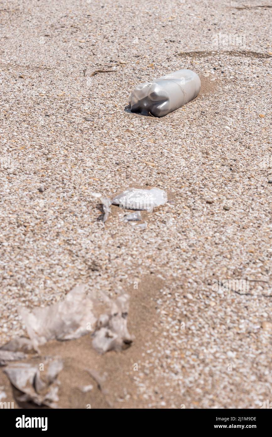Plastic bottle lying on the sand near the beach. Let's take care of the planet Stock Photo