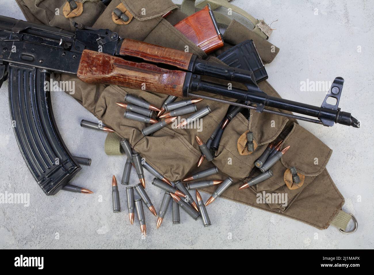 Kalashnikov ak gun and Chicom Chest Rig with 7 62 mm cartridges on