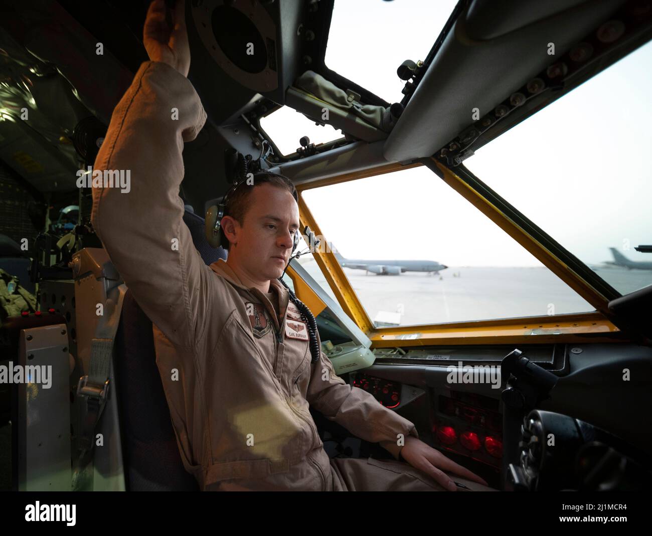 U.S. Air Force Capt. Carl Burnham, a U.S. Air Force KC-135 Stratotanker pilot assigned to the 340th Expeditionary Air Refueling Squadron, conducts pre-flight checks at Al Udeid Air Base, Qatar, March 12, 2022. The 340th EARS, deployed with Ninth Air Force (Air Forces Central), is responsible for delivering fuel to U.S. and coalition forces, enabling war-winning air power, deterrence and stability to the region. (U.S. Air Force photo by Tech. Sgt. Christopher Ruano) Stock Photo