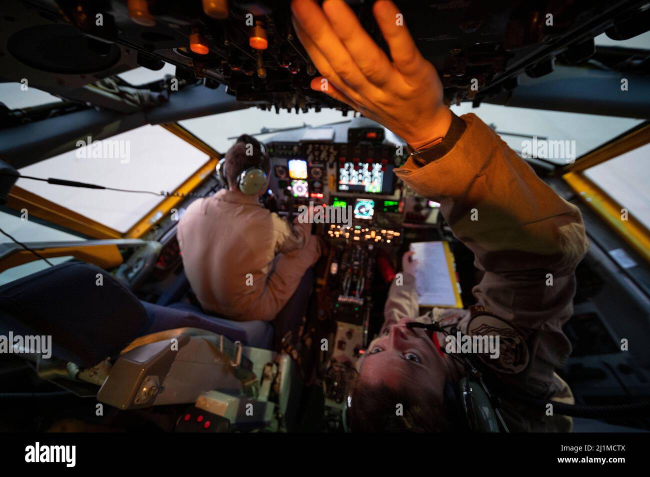 U.S. Air Force Capt. Carl Burnham (left) and 1st Lt. Stephanie Staples (right), U.S. Air Force KC-135 Stratotanker pilots assigned to the 340th Expeditionary Air Refueling Squadron, conduct pre-flight checks at Al Udeid Air Base, Qatar, March 12, 2022. The 340th EARS, deployed with with Ninth Air Force (Air Forces Central), is responsible for delivering fuel to U.S. and coalition forces, enabling war-winning air power, deterrence and stability to the region. (U.S. Air Force photo by Tech. Sgt. Christopher Ruano) Stock Photo