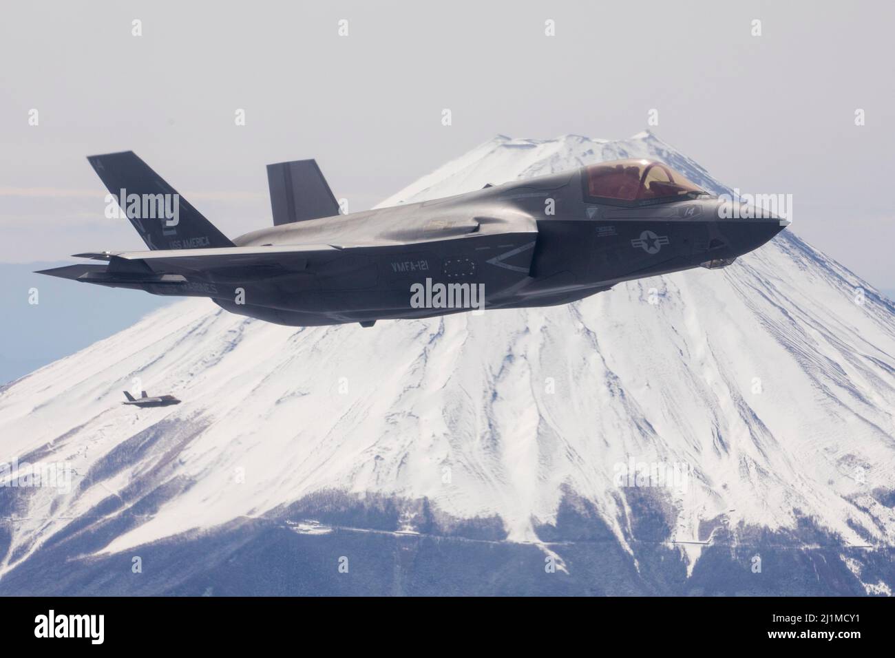 U.S. Marine Corps F-35B Lightning II’s with Marine Fighter Attack Squadron (VMFA) 121 fly near Mt. Fuji, Japan, March 23, 2022. Marines with Marine Aerial Refueler Transport Squadron 152 supported Marines with VMFA-121 during a training flight simulating close air support at Camp Fuji, Japan. Marine Corps aviation routinely conducts training throughout the region to remain combat-ready in support of a free and open Indo-Pacific and to demonstrate our commitment to the Treaty of Mutual Cooperation and Security between the U.S. and Japan. (U.S. Marine Corps photo by Cpl. Tyler Harmon) Stock Photo