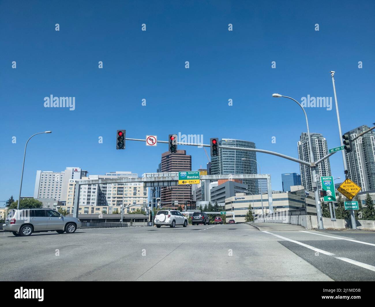 Bellevue, WA USA - circa July 2021: Street view of the entrance ramp to i-405 South above busy downtown traffic on a sunny day. Stock Photo