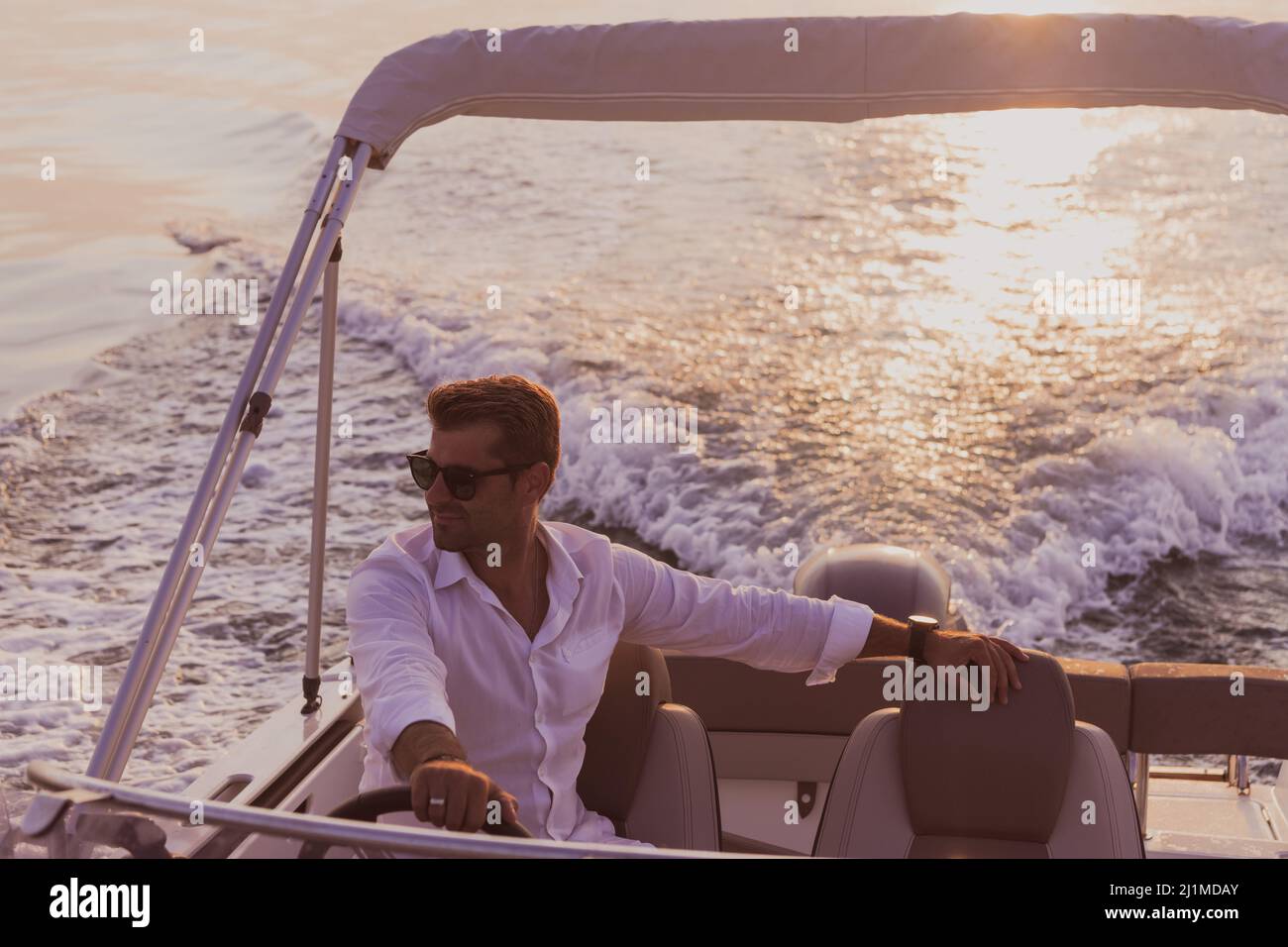 Kid driving boat hi-res stock photography and images - Alamy