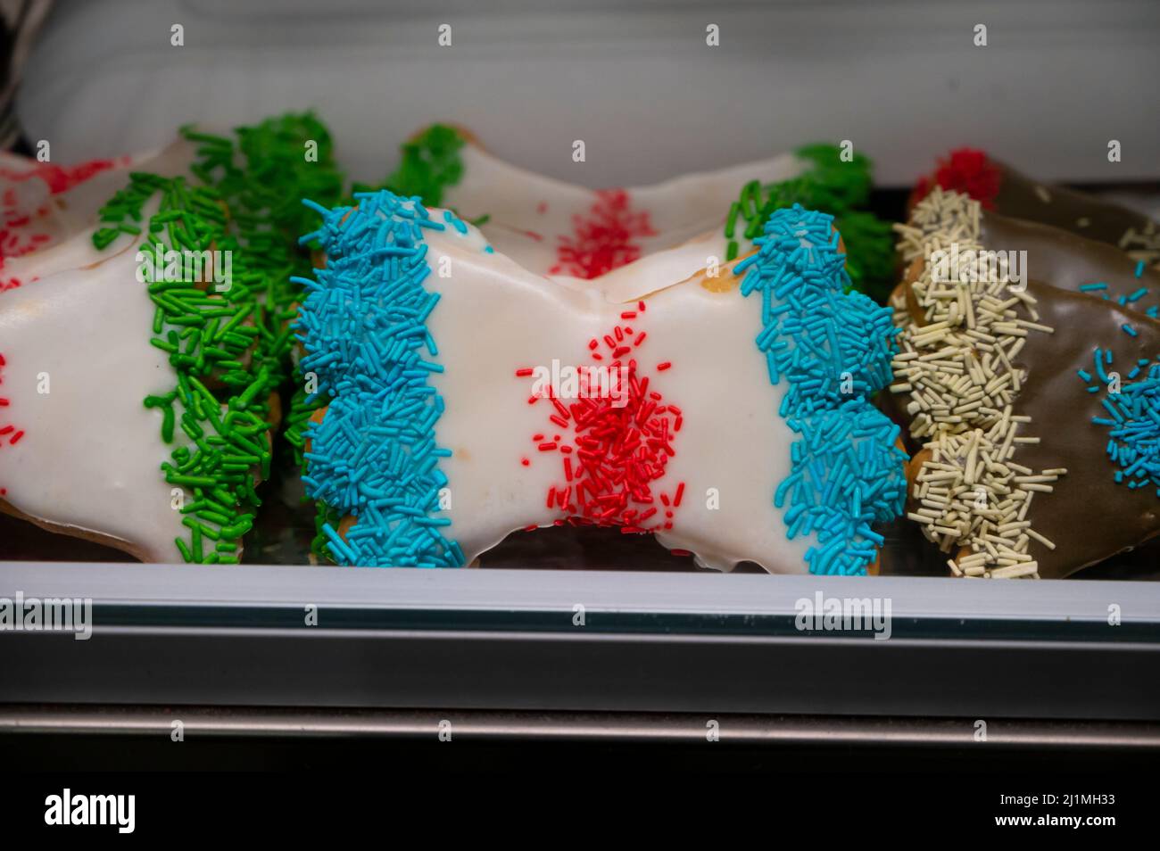 Sweet colorful bowshaped biscuits on display at Italian bakery Stock