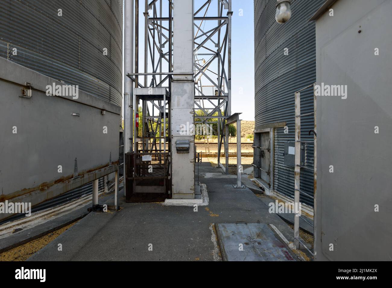 The bottoms of metal grain bins at a grain elevator, central Washington