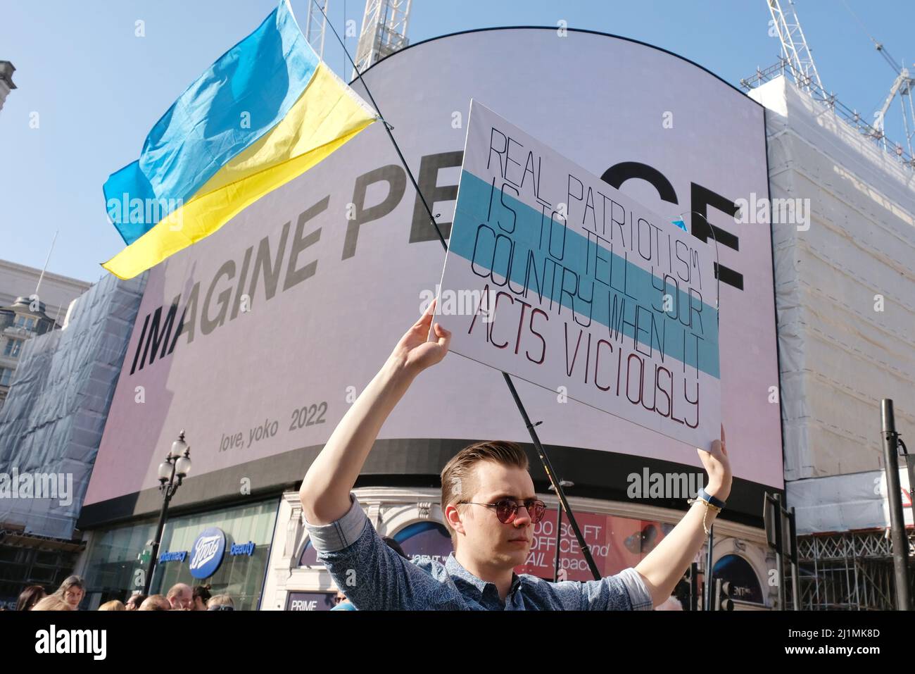 London, UK, 26th Mar, 2022. A man holds up a placard with the anti-war white, blue, white flag design expressing his opinion. He was one of thousands gathered to show solidarity with Ukraine in a march and rally taking place Central London, organised by the European Movement and supported by the Mayor of London. One month after the Russian Invasion Ukrainian president Volodymyr Zelenskyy urged global protests to bring the war to an end. Credit: Eleventh Hour Photography/Alamy Live News Stock Photo