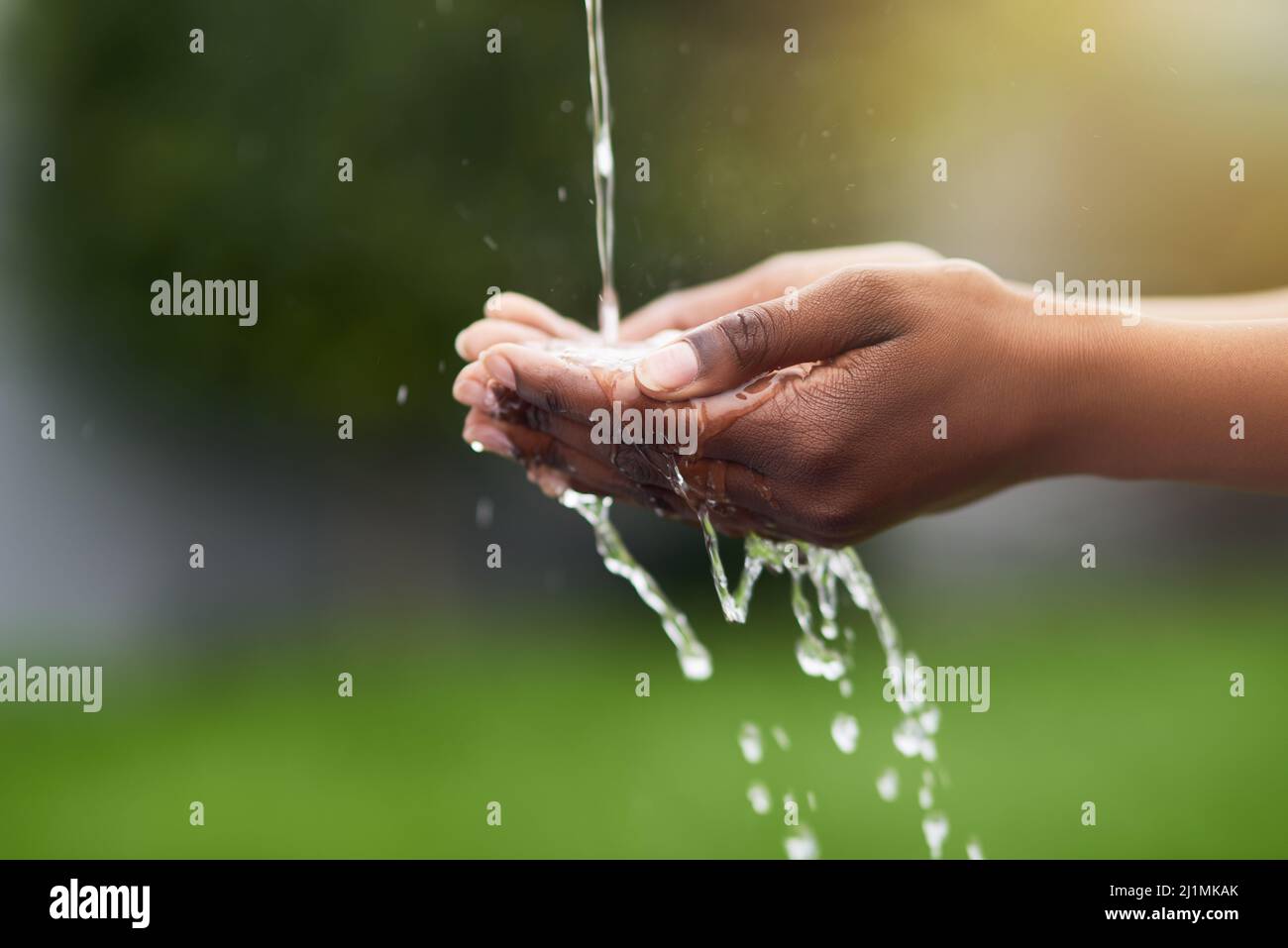 Water...the source of all life. Cropped shot of a woman washing her hands outdoors. Stock Photo
