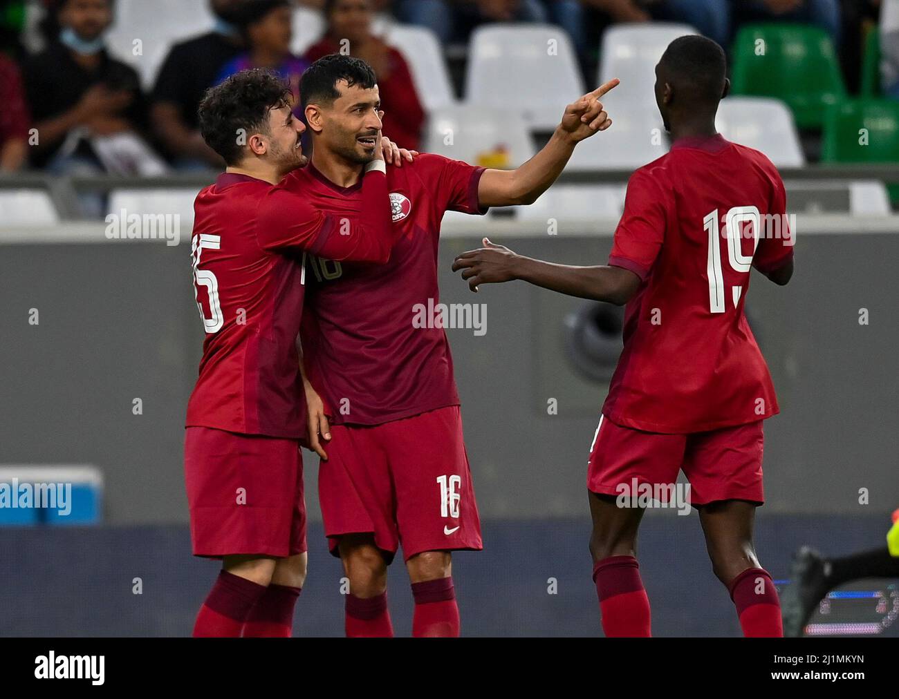 Doha, Qatar. 26th Mar, 2022. Boualem Khoukhi (C) of Qatar celebrates ...