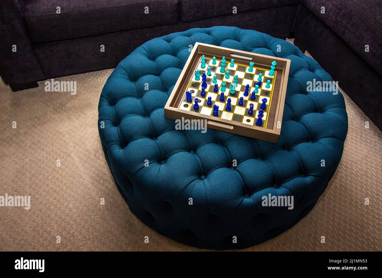 Colorful Chess Board On Blue Ottoman Stock Photo