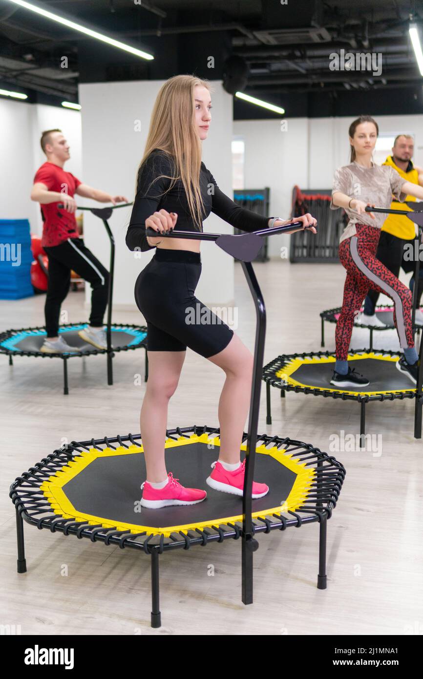 Women's and men's group on a sports trampoline, fitness training, healthy  life - a concept trampoline group batut workout health, In the afternoon  Stock Photo - Alamy