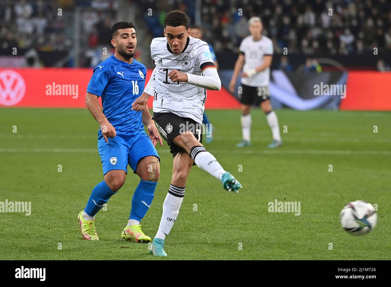 Sinsheim PreZero Arena. 26th Mar, 2022. Jamal MUSIALA (GER), action, duels versus Mohammad ABU FANI (ISR). Soccer Laenderspiel Germany - Israel 2-0, on March 26th, 2022 in Sinsheim PreZero Arena. Sven Simon Photo Agency GmbH & Co. Press Photo KG # Princess-Luise-Str. 41 # 45479 M uelheim/R uhr # Tel. 0208/9413250 # Fax. 0208/9413260 # GLS Bank # BLZ 430 609 67 # Kto. 4030 025 100 # IBAN DE75 4306 0967 4030 0251 00 # BIC GENODEM1GLS # www.svensimon.net ##UEFA regulations prohibit any use of photographs as image sequences and/ or quasi -Video##. Credit: dpa/Alamy Live News Stock Photo