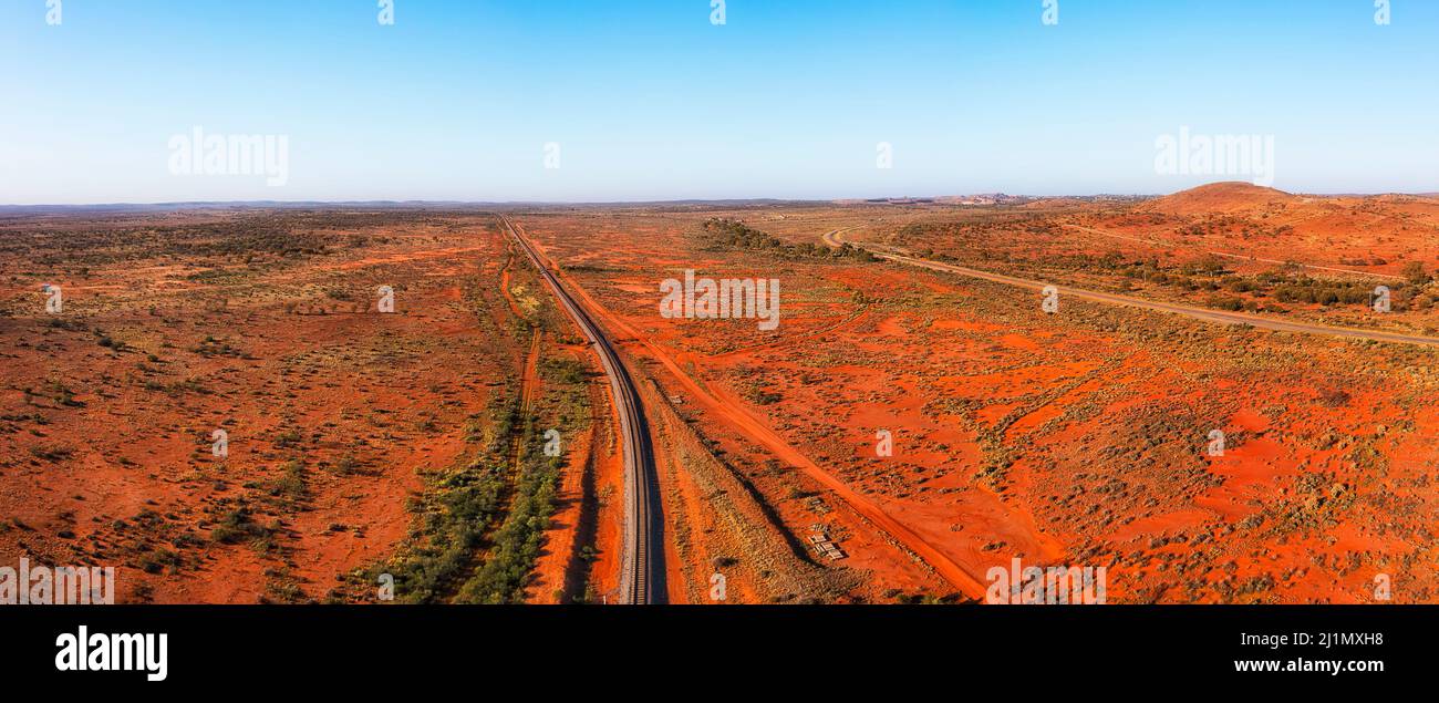 Railway track and Barrier Highway in outback near Broken Hill mining city of Far West NSW, Australia - aerial panorama. Stock Photo
