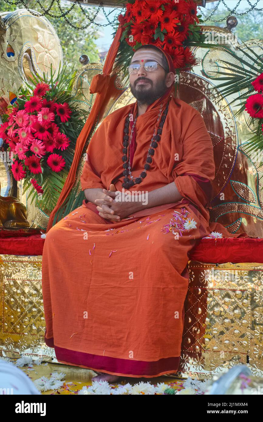 A revered Hindu priest, a Brahmin by caste, is sitting on a throne-like seat at Balkrishna Temple, Udupi (Udipi), Karnataka, South India Stock Photo