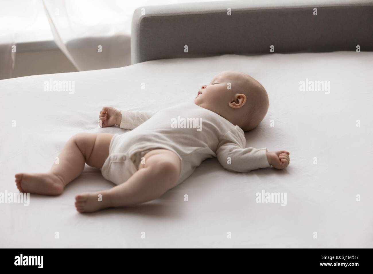 Peaceful adorable little newborn baby sleeping on sofa Stock Photo Alamy