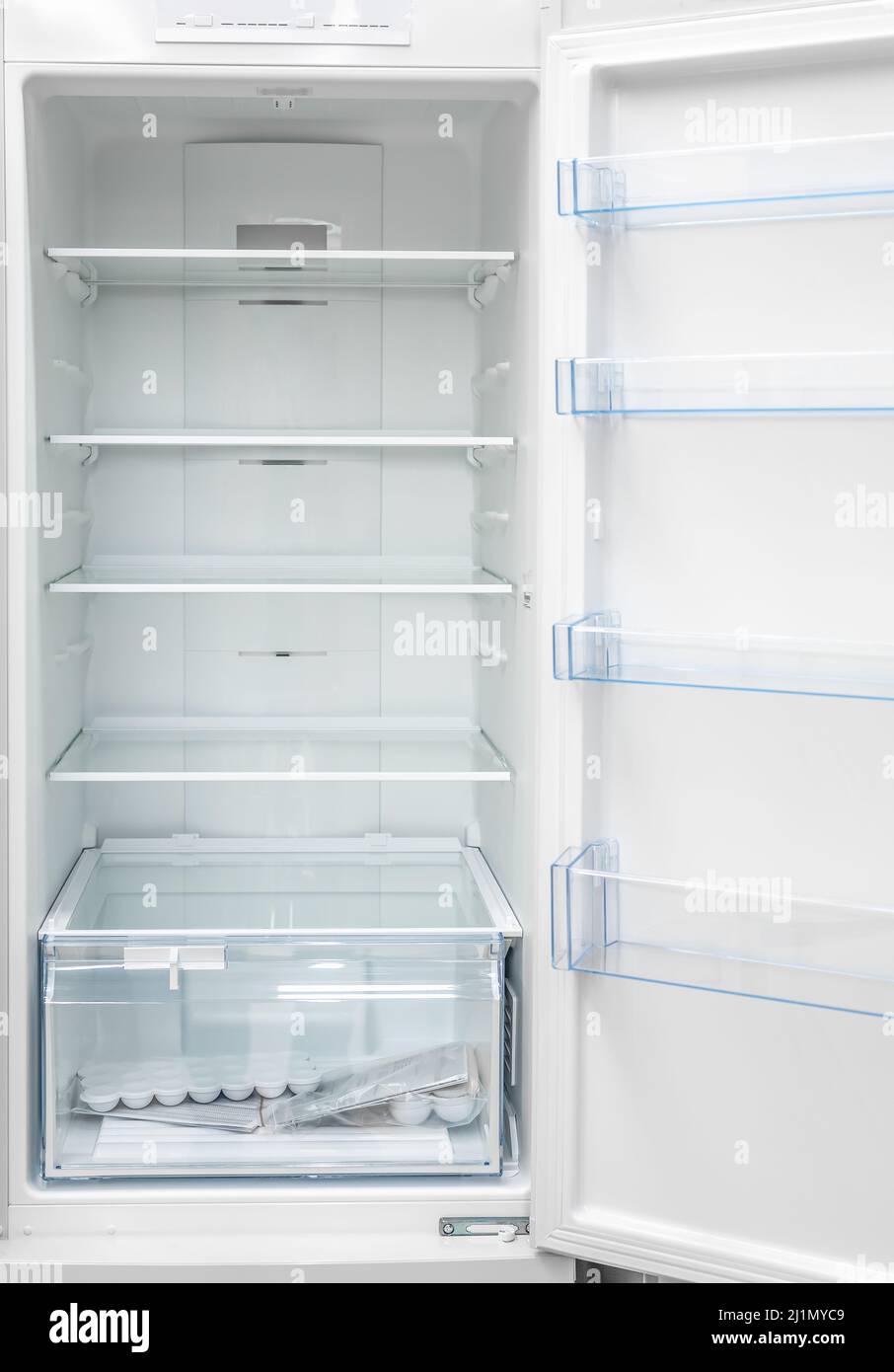 New clean refrigerator. Opened empty refrigerator. Refrigerator open empty fridge inside interior. close up on empty freezer with door open. empty she Stock Photo