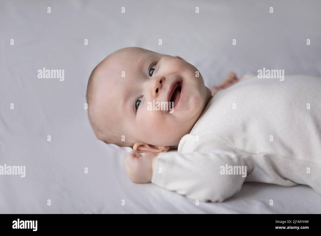 Close up portrait of happy small cute baby boy girl. Stock Photo