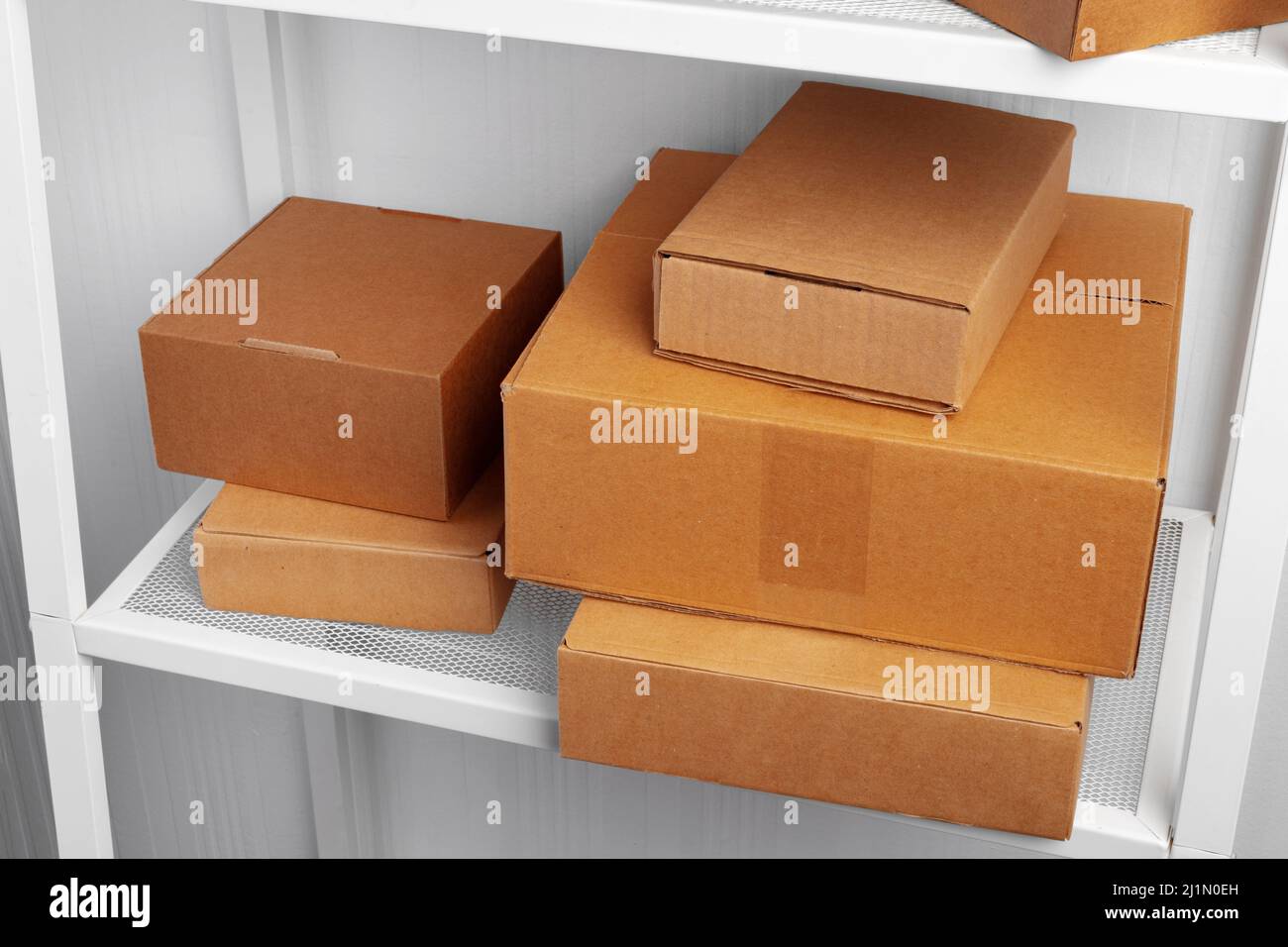 Stack of cardboard package boxes on wooden rack Stock Photo Alamy