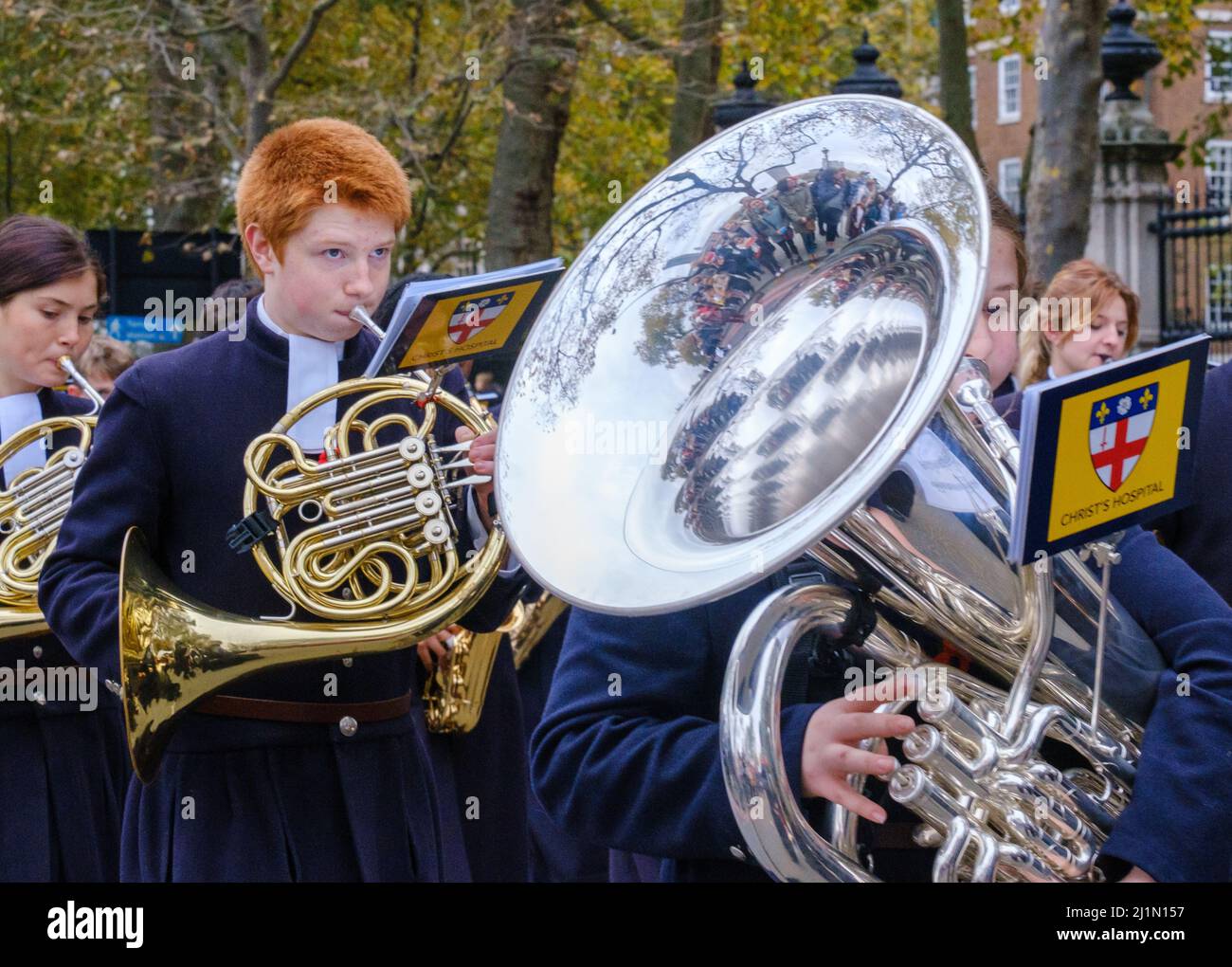 Close up of ginger haired boy playing French Horn and girl playing tuba with Christ’s Hospital School Band in the Lord Mayor’s Show 2021, London. Stock Photo