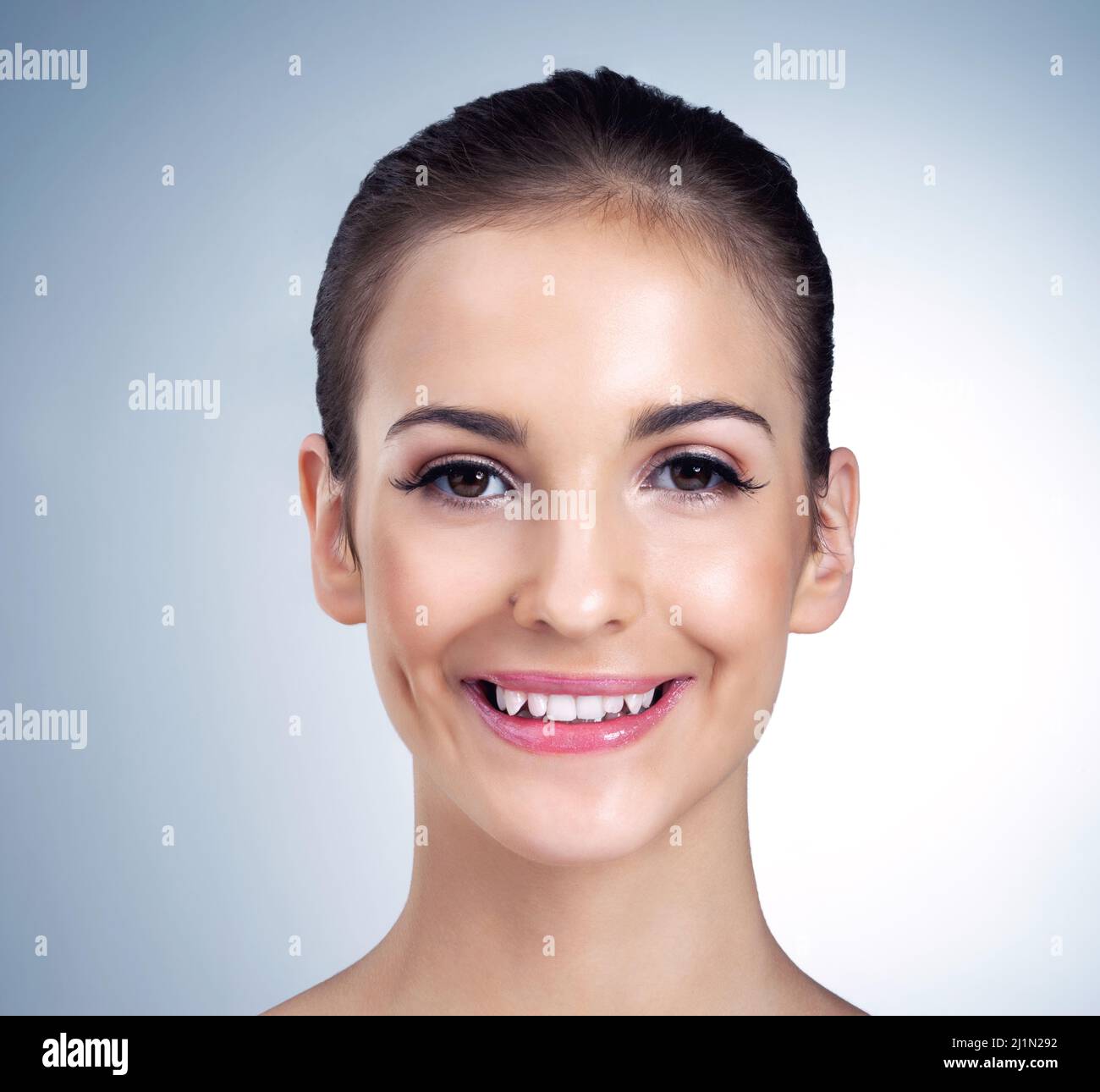 Shes simply beautiful. Studio portrait of a beautiful young model posing against a blue background. Stock Photo