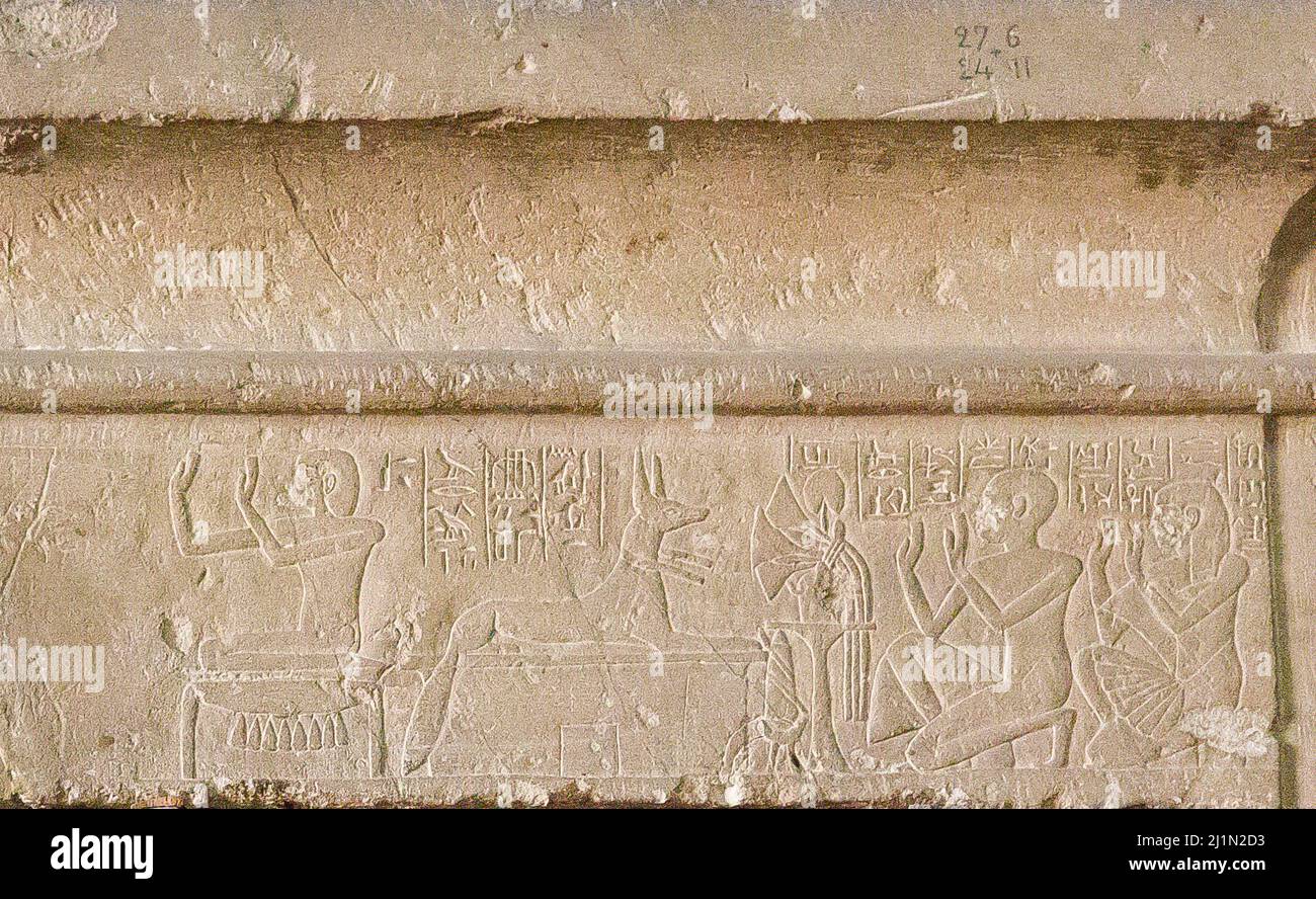 Cairo, Egyptian Museum, from Guiza, tomb of Khaemouaset. Lintel with cornice, deceased and his son Ptahnufer kneeling before  Isis and Anubis. Stock Photo