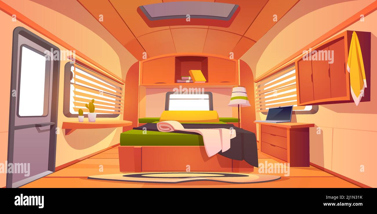 Camping trailer car interior with unmade bed, desk with laptop, shelf