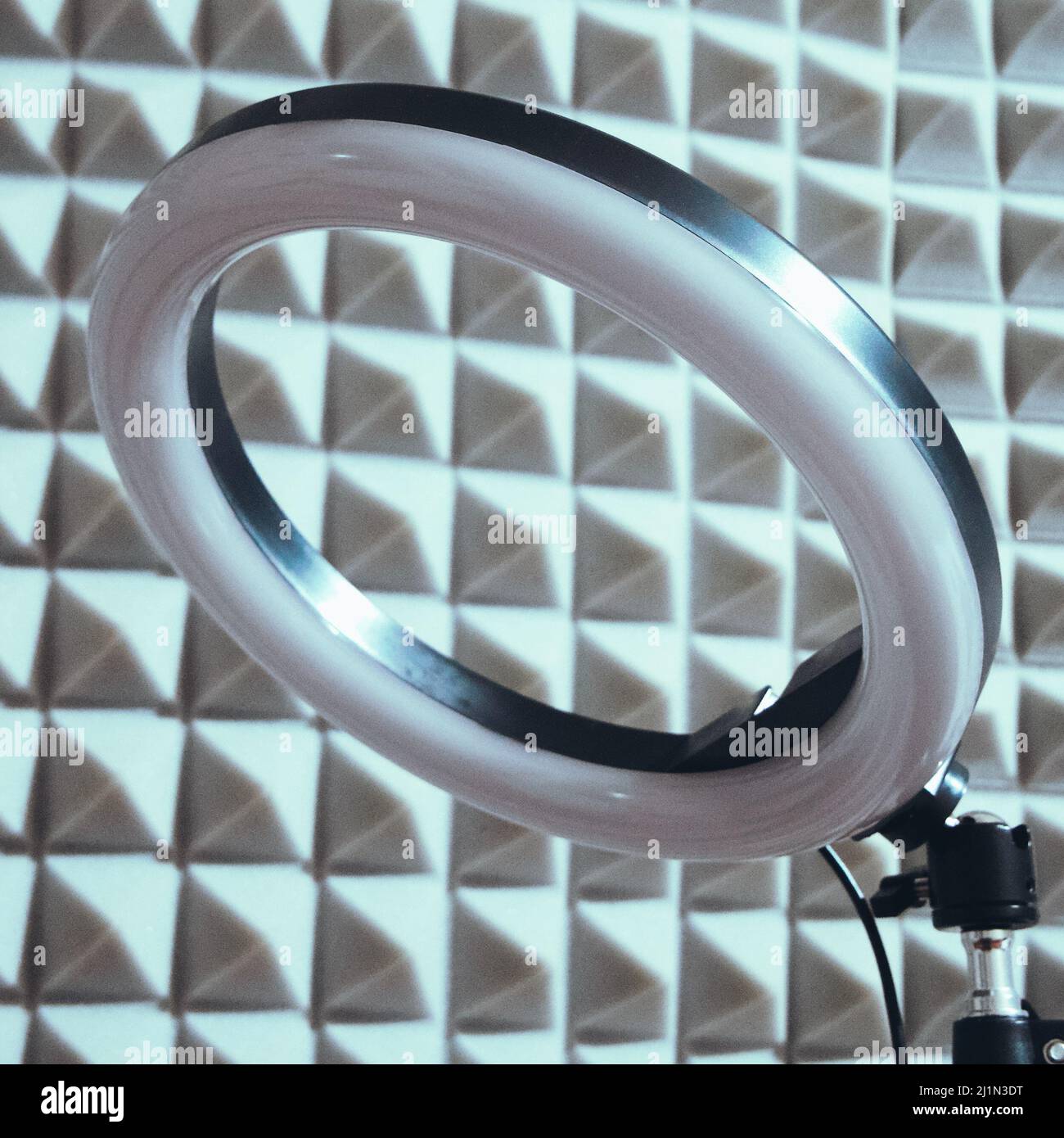 Ring RGB lamp on the background of sound-proof foam rubber. Stock Photo