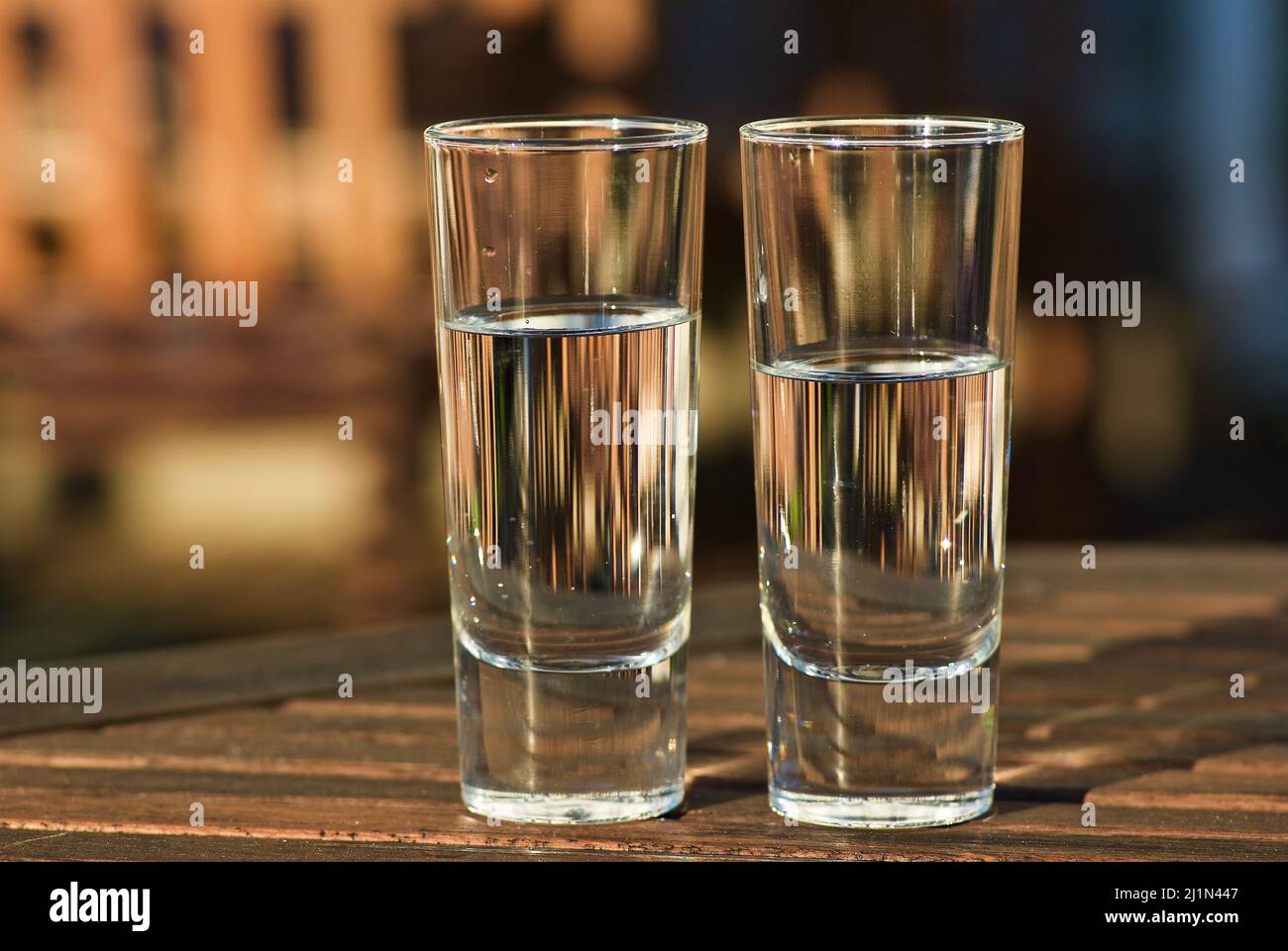 Two glasses with fresh still water outdoors in the summer evening. Stock Photo