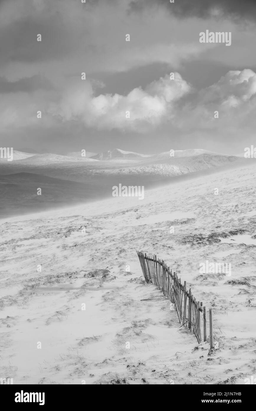Black and white Winter landscape image from mountain top looking across to Rannoch Moor Stock Photo