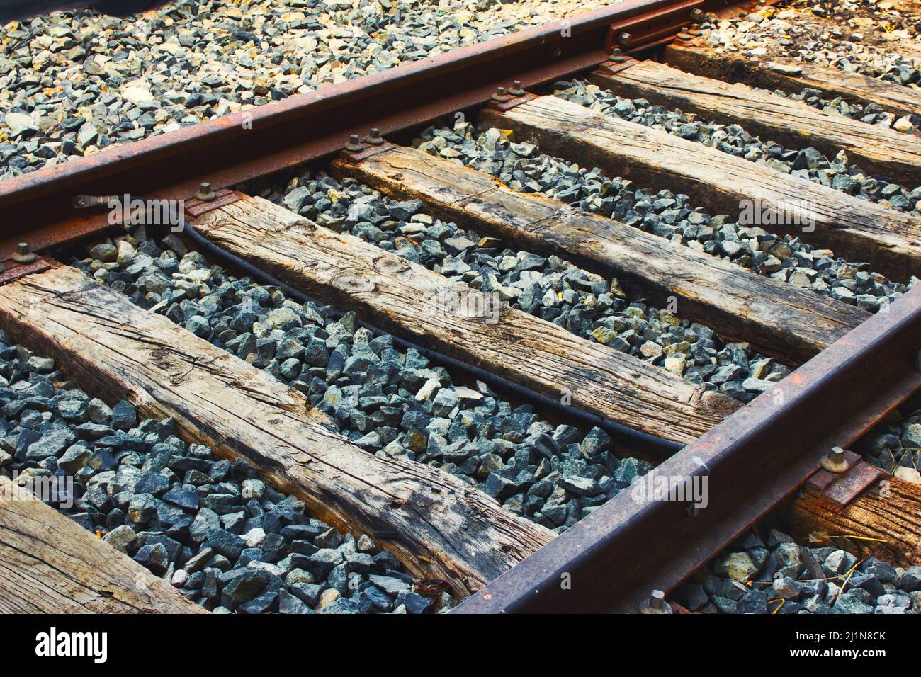 Close-up of train tracks, steel rails and wooden sleepers Stock Photo