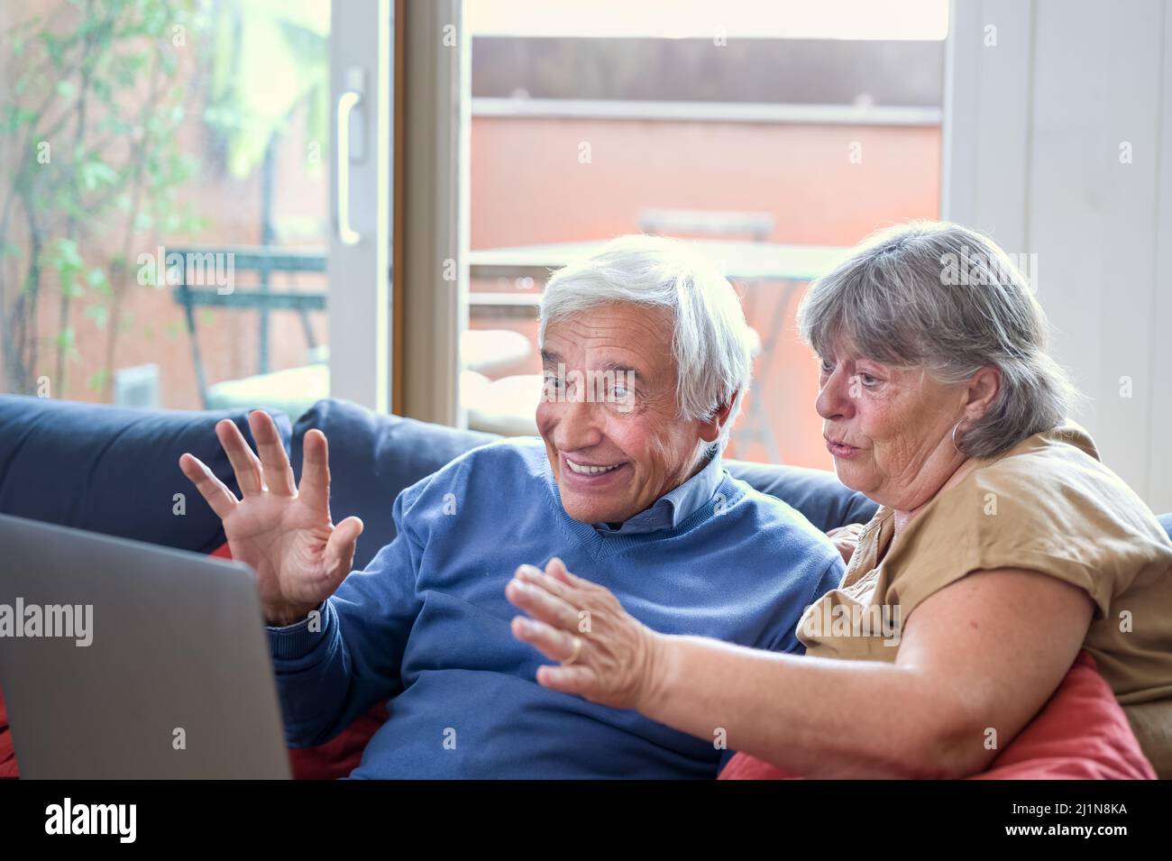 happy grandparents making a video call with a modern device, elder