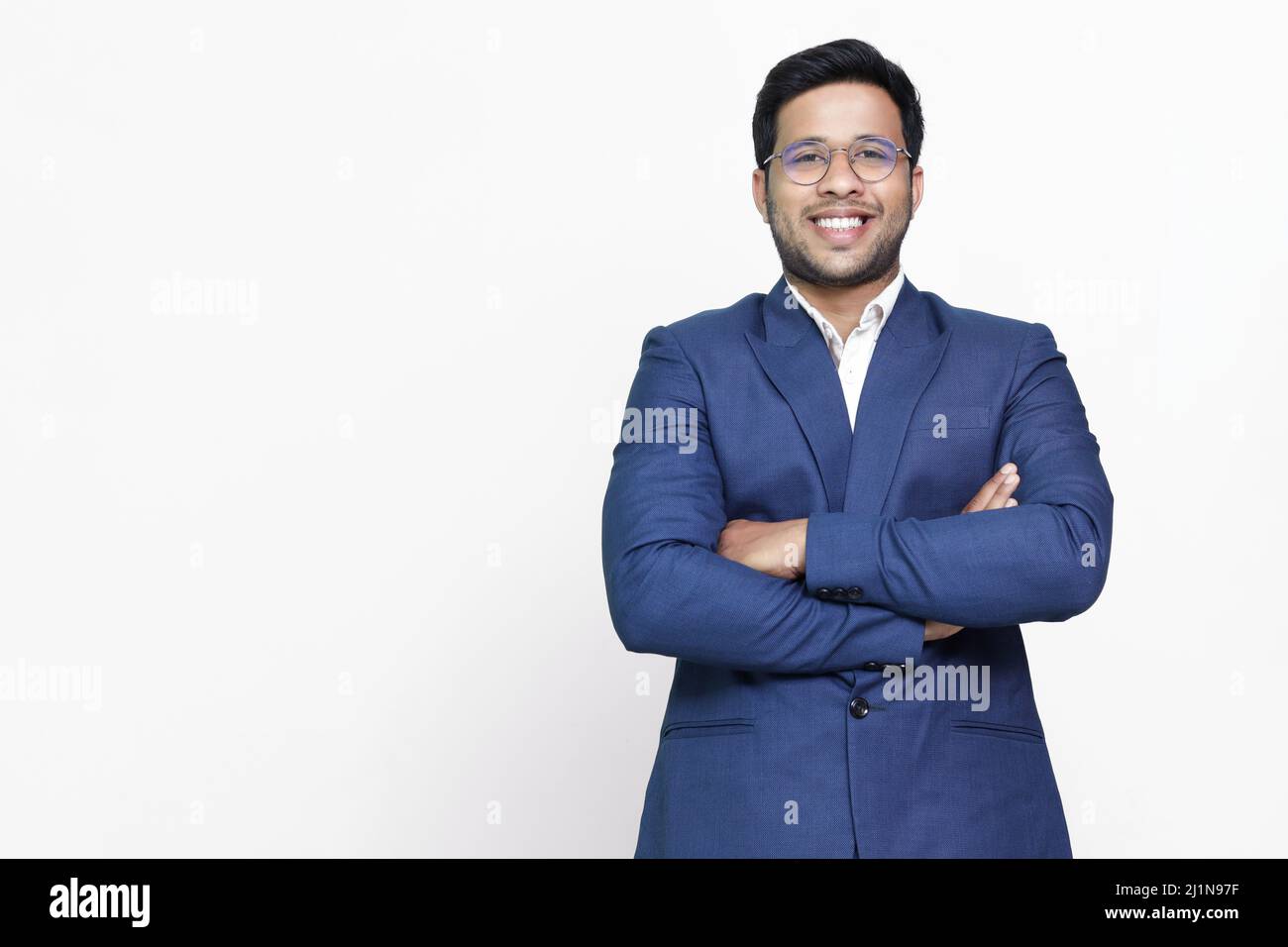 Young hispanic businessman with arms crossed smiling happy Stock Photo ...
