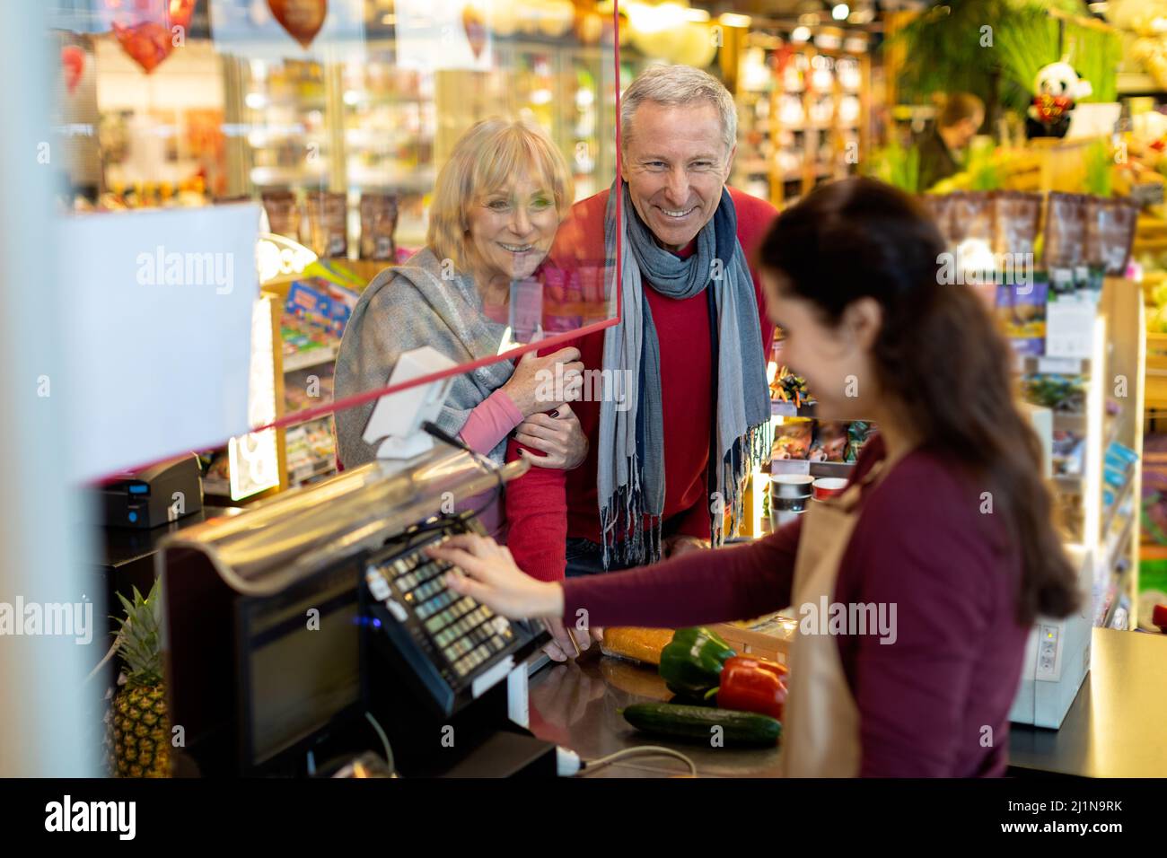 Female Cashier Chatting With Customers At Supermarket Stock Photo Alamy