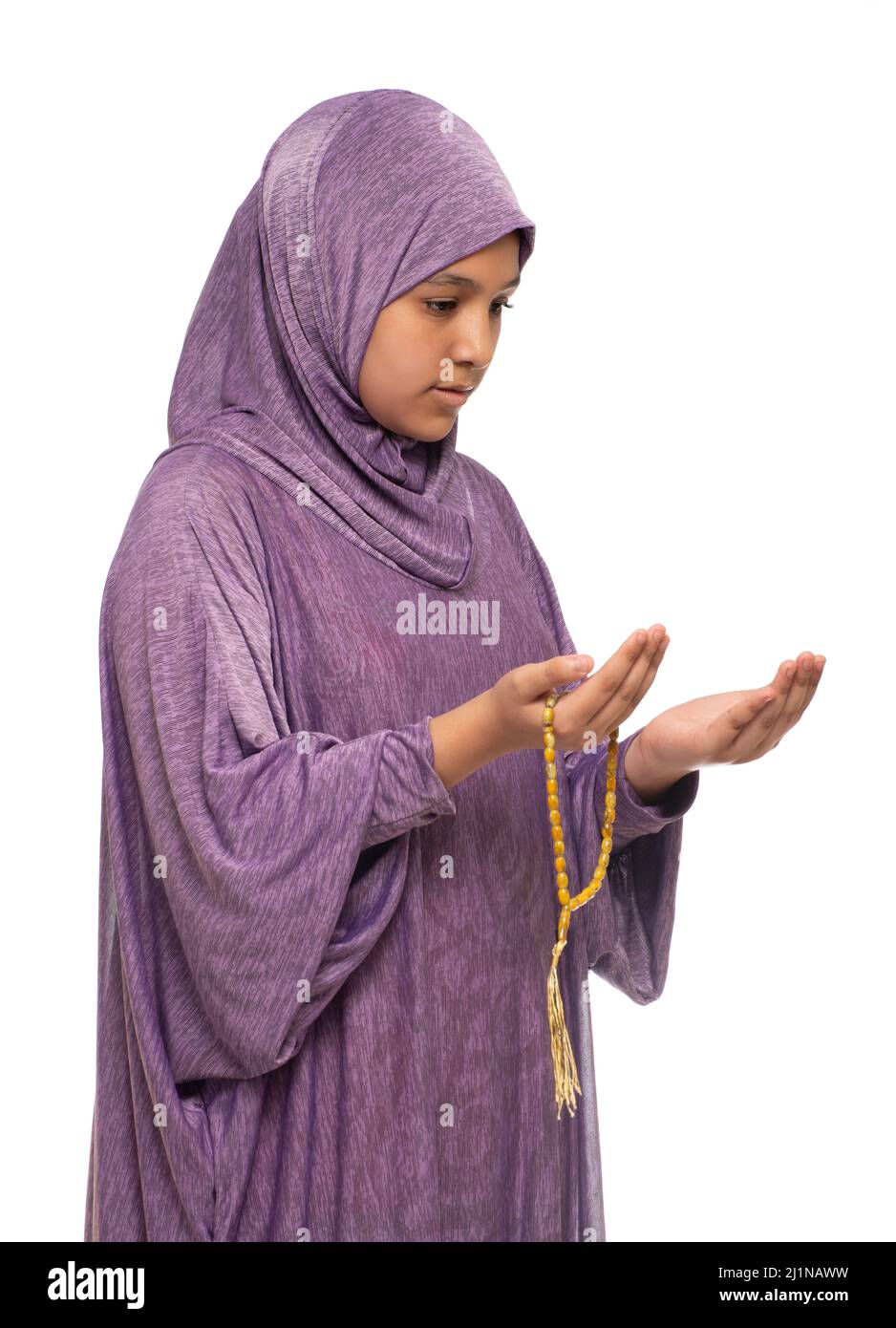 Little Muslim Female Praying for Allah, Girl with Prayer Costume and Rosary, Ramadan Kareem Concept, Isolated on White Background Stock Photo