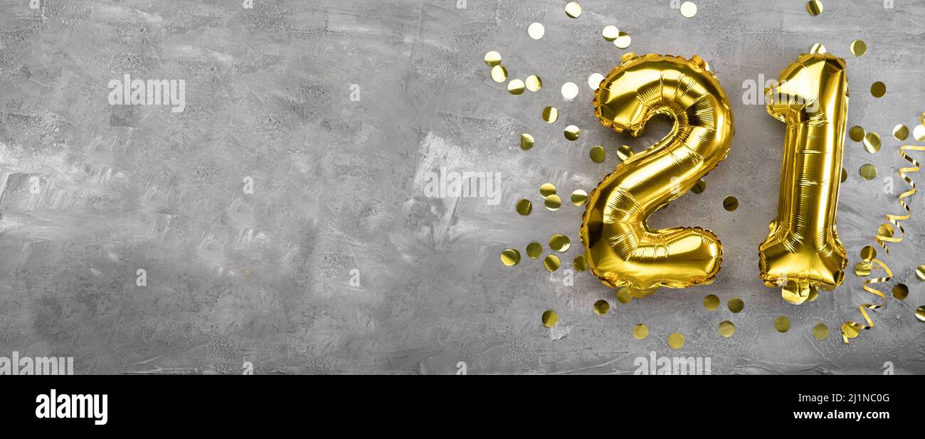 Yellow foil balloon number, number twenty one on a concrete background. Birthday card with inscription 21. Anniversary concept. for anniversary Stock Photo