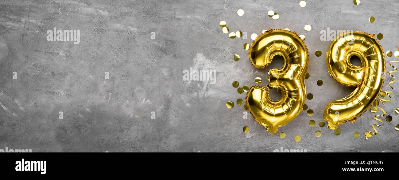 Yellow foil balloon number, number thirty on concrete background. Greeting card with the inscription 39. Anniversary concept. for anniversary Stock Photo