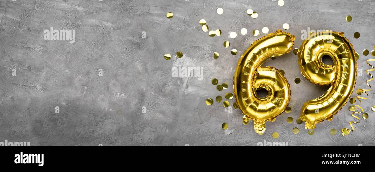 Yellow foil balloon number, number sixty nine on a concrete background. Greeting card with the inscription 69. Anniversary concept. for anniversary Stock Photo