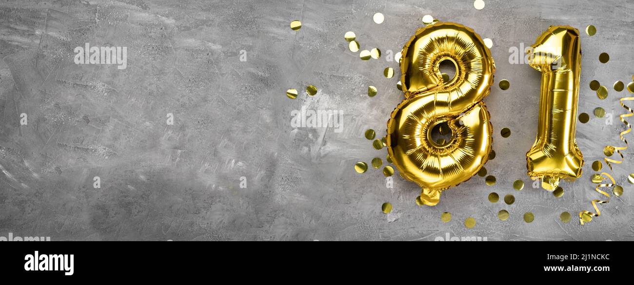 Yellow foil balloon number, number eighty one on a concrete background. Greeting card with the inscription 81. Anniversary concept. for anniversary Stock Photo