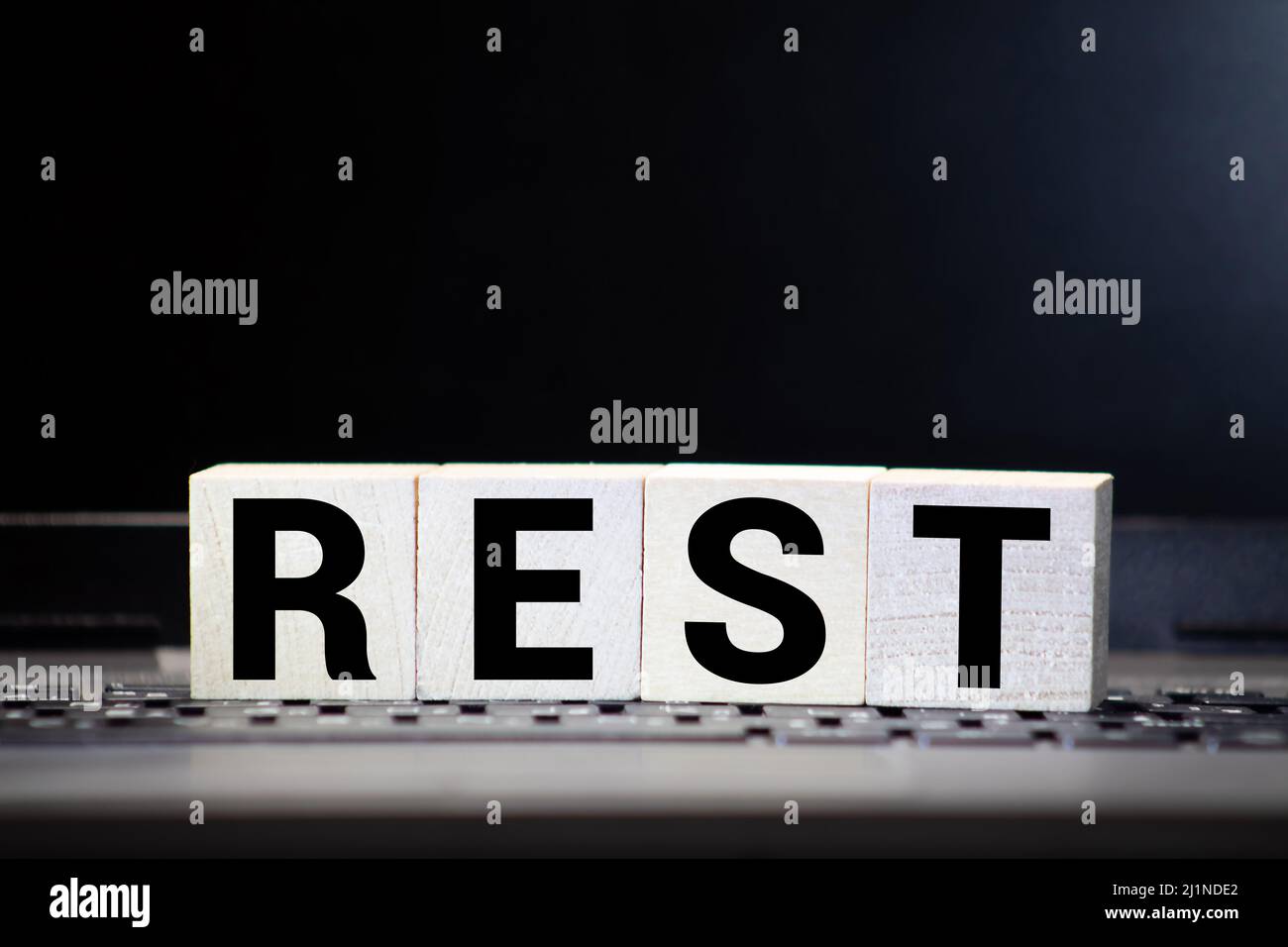 Rest word from wooden blocks on desk Stock Photo