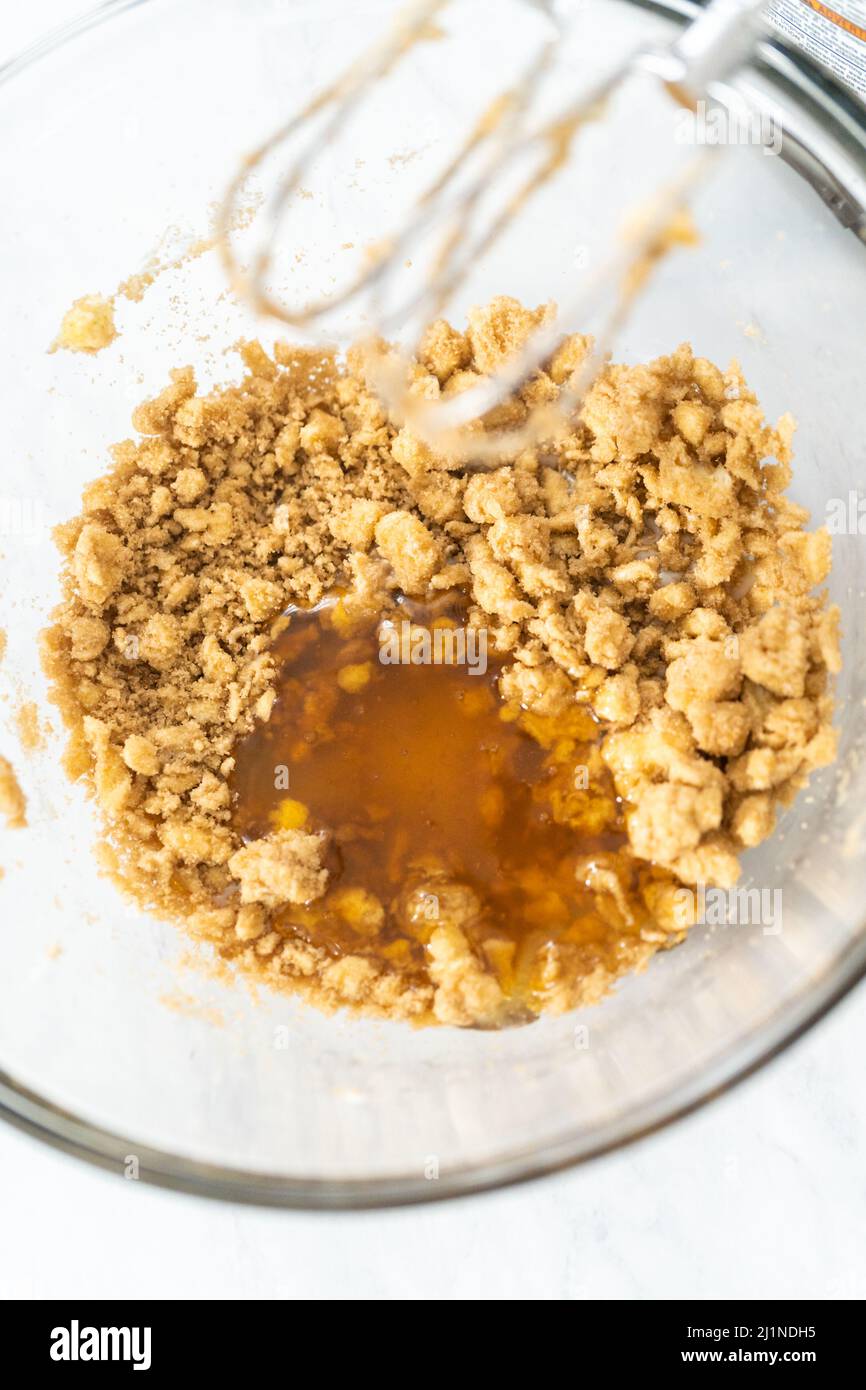 Mixing ingredients in a glass mixing bowl to bake chocolate graham