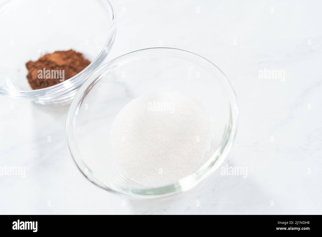 Mixing ingredients in a glass mixing bowl to bake chocolate graham